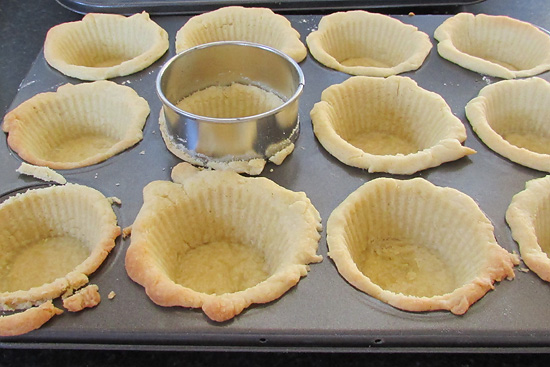 Cooked pastry cases being trimmed