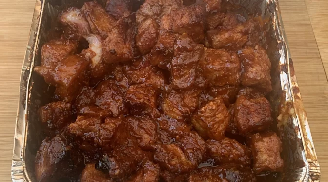 A picture of squares of pork belly with barbecue sauce on them