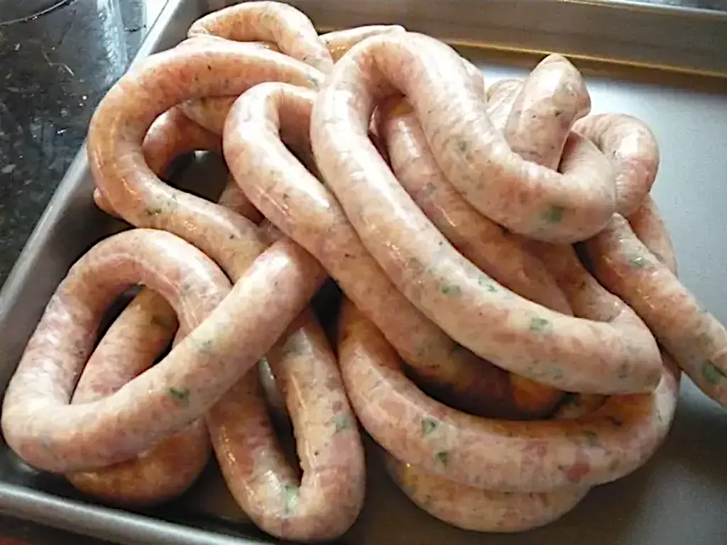 A picture of a long string of chicken sausage.