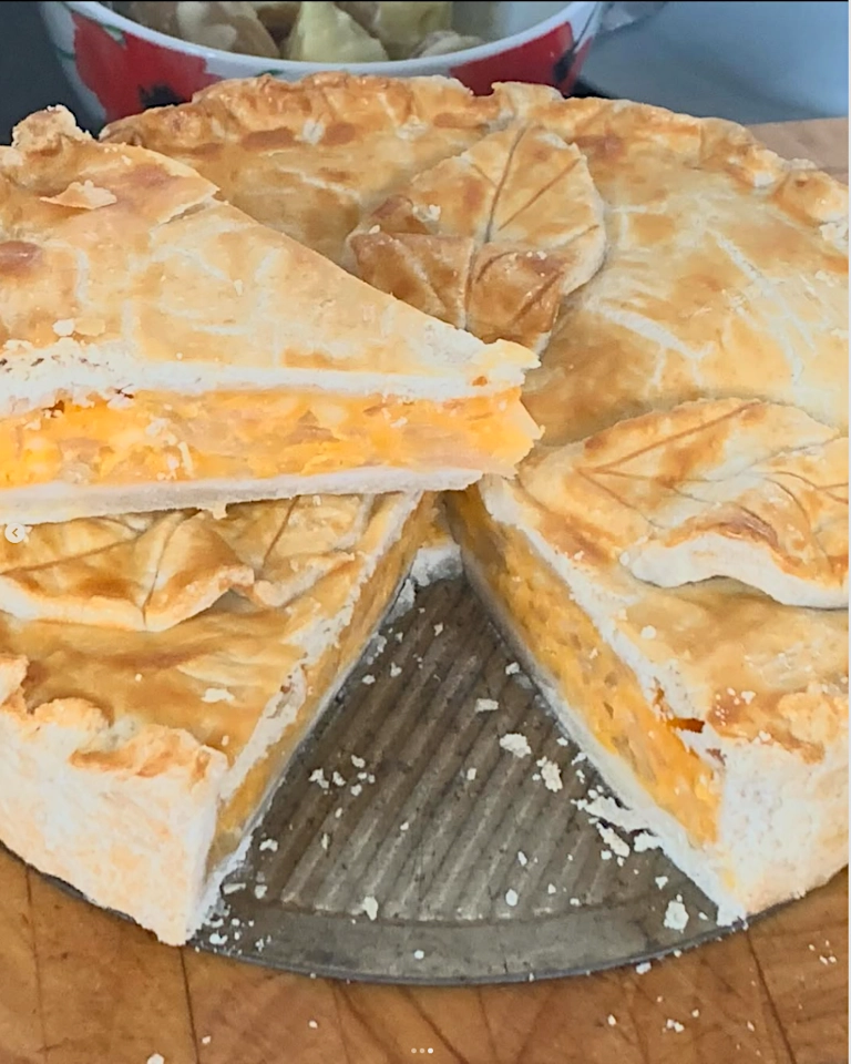 Cheese-onion A picture of a wedge of cheese and onion pie on top of the pie it was cut from.