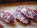 A picture of slices of a snack stick salami.